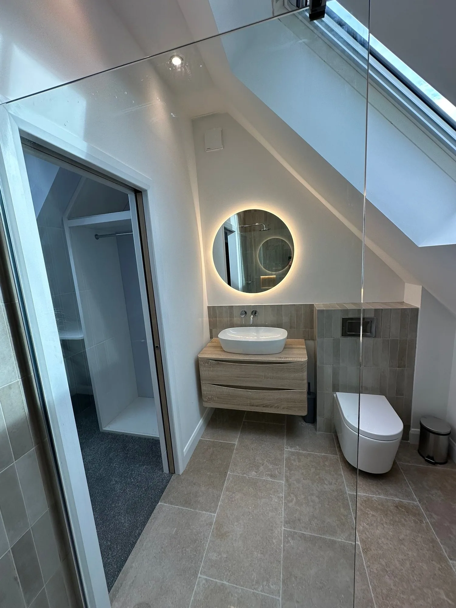 Contemporary loft ensuite showing vanity, WC and walk-in area through the glass screen