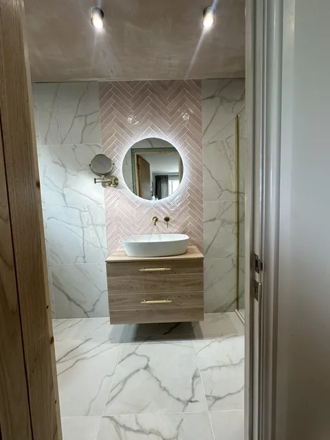Newly fitted bathroom with tiled shower and glass screen