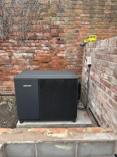 Ground source heat pump manifold and pump station in a utility room